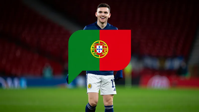 Andy Robertson in Scotland kit, smiling, with Portuguese flag emoji overlay, symbolizing his companion at the 2026 World Cup.