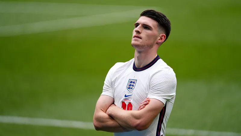 Declan Rice in an England shirt, looking proud and focused on the pitch.