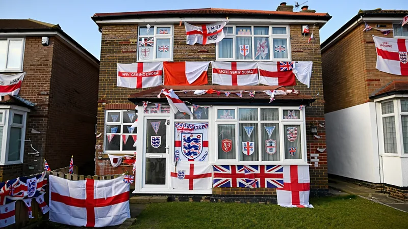 Exterior of a house in Burnage, Manchester, covered in England flags, badges, and bunting for a football tournament. — latest news and analysis.