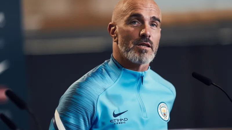 Enzo Maresca speaking at a press conference, wearing a Manchester City training kit.
