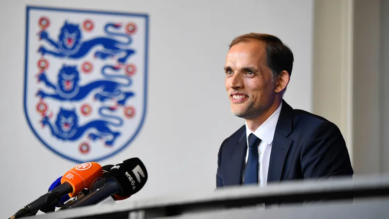Tuchel's journey from hip-hop parties to England boss Thomas Tuchel, England manager, smiling during a press conference, with the Three Lions crest in the background. — latest news and analysis.