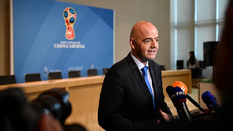 FIFA President Gianni Infantino speaking at a press conference, with a World Cup logo visible in the background. — latest news and analysis.