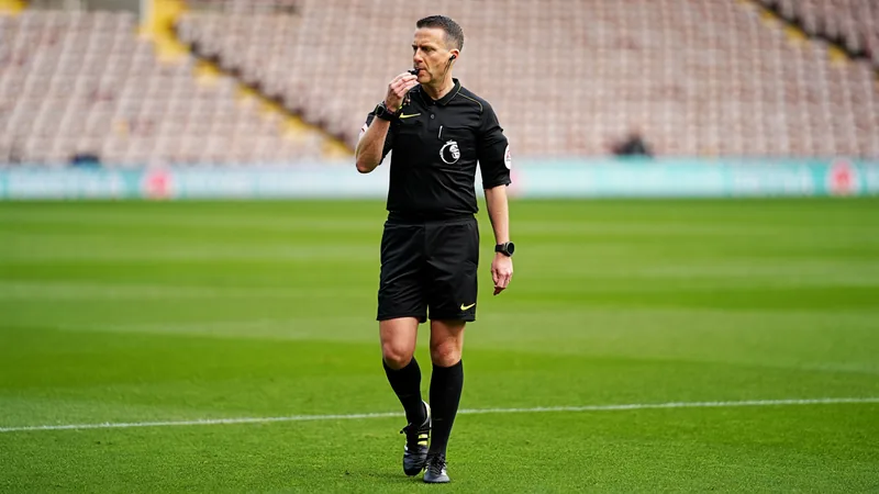 Injured referee Michael Oliver to miss World Cup match Michael Oliver, an English football referee in his official kit, standing on a pitch with a whistle in hand. — latest news and analysis.
