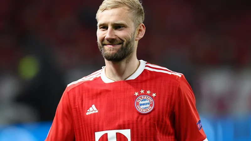 Konrad Laimer in Bayern Munich kit, smiling during a match