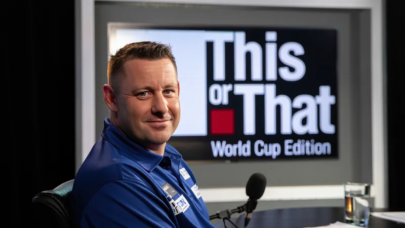 Luke Humphries smiling during a 'This or That' interview with World Cup themed questions.