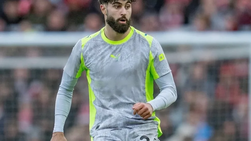Man City Optimistic on Gvardiol Contract Extension Josko Gvardiol in Manchester City kit during a match, with the Etihad Stadium in the background. — latest news and analysis.