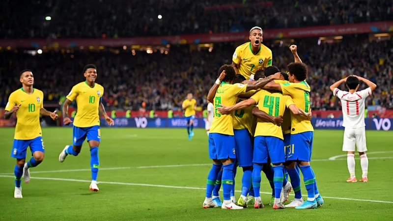Brazilian players celebrate after Gabriel Martinelli's late goal against Japan