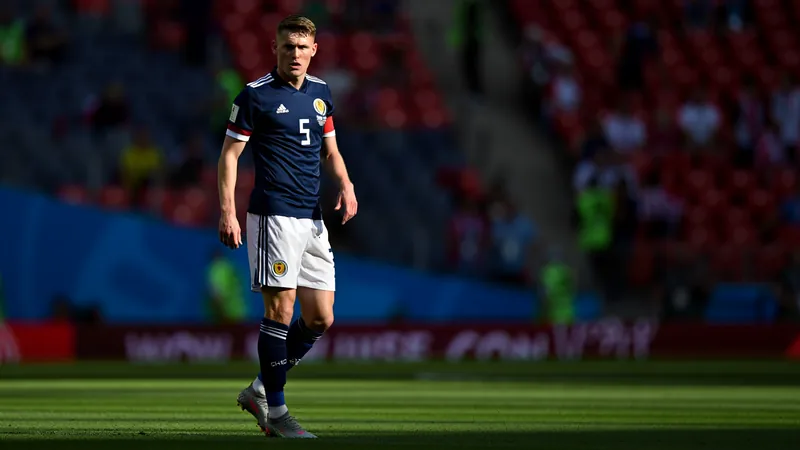 Scott McTominay in Scotland kit during World Cup match, looking focused on the pitch.