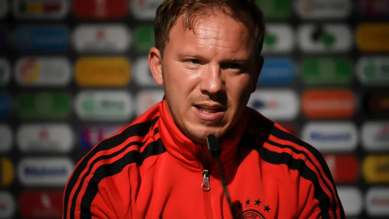 Julian Nagelsmann speaking at a press conference, wearing a Germany team jacket.