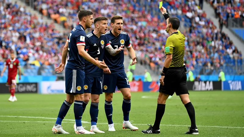 Scotland denied penalties in 1-0 World Cup loss to Morocco Scotland players argue with referee Ilgiz Tantashev during a World Cup match against Morocco, with fans in the background.
