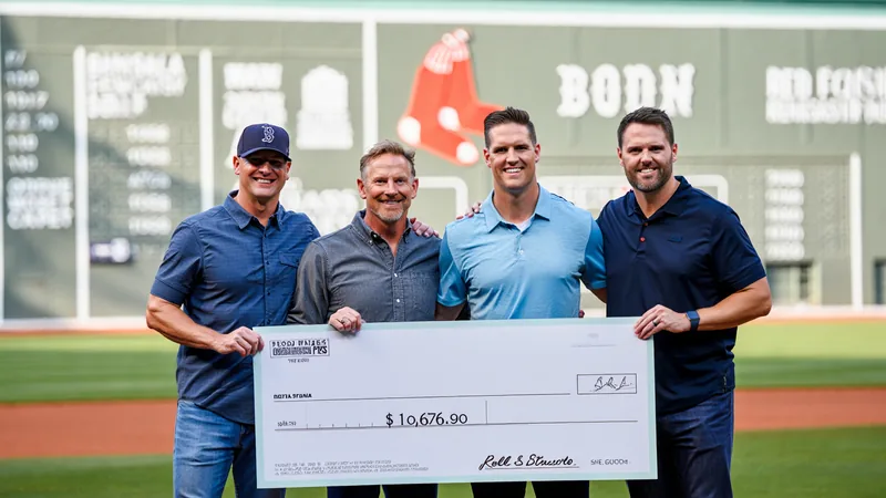 Scottish fans win $10,676 in Boston Red Sox raffle Four Scottish men holding a large cheque for $10,676.90 at Fenway Park, with the Boston Red Sox logo in the background. — latest news and analysis.
