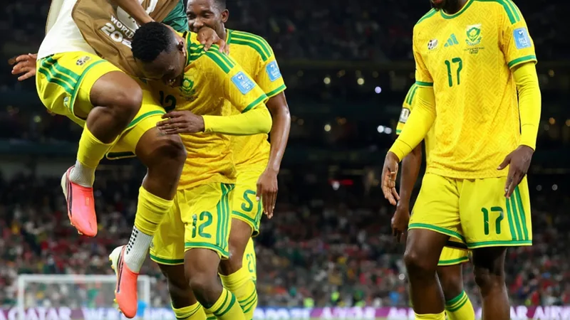 South African football players celebrating their historic advancement to the World Cup knockout stage — latest news and analysis.