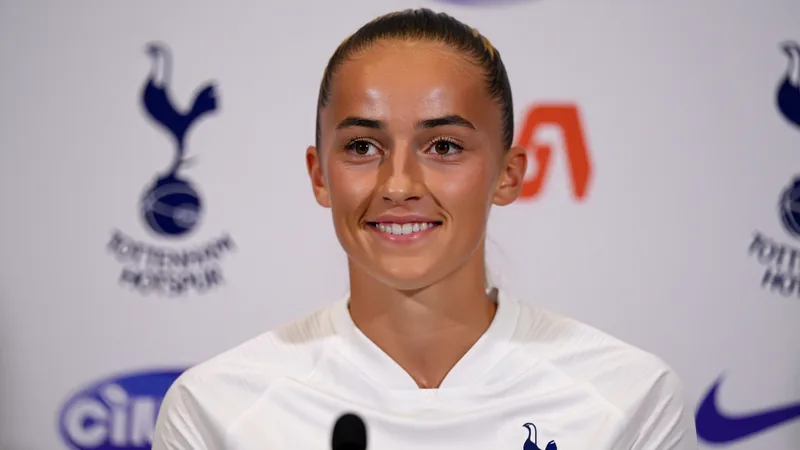 Victoria Pelova in Tottenham Hotspur kit, smiling during her official signing announcement.