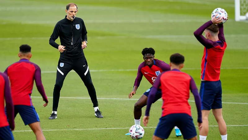 England head coach Thomas Tuchel directs a training session with players practicing set-pieces on a grass field. — latest news and analysis.