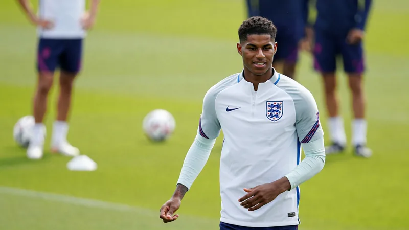 Marcus Rashford in an England jersey, smiling during a training session ahead of the World Cup. — latest news and analysis.