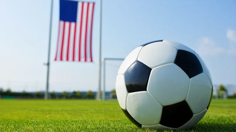 A soccer ball on a field with US flag in background, representing low World Cup awareness in America. — latest news and analysis.