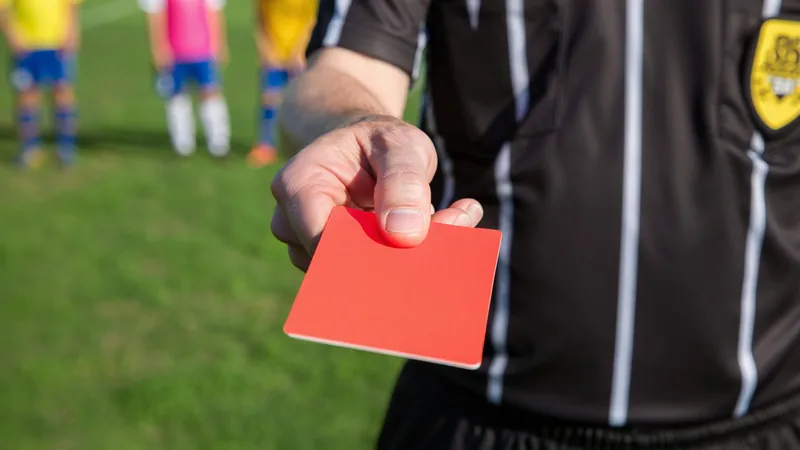 World Cup red card suspension rules explained A red card held up by a referee during a football match.