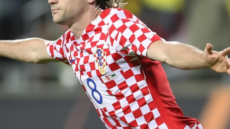 Lovro Majer in action for Croatia national team, wearing red and white checkered jersey