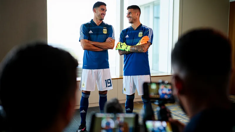 Julian Alvarez and Emiliano Martinez in Argentina kits, discussing England match