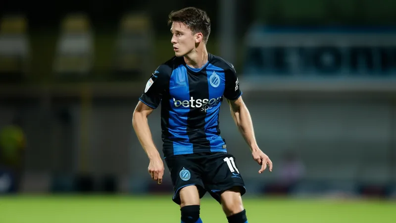 Arsenal agree €40m deal for Christos Tzolis Christos Tzolis in action for Club Brugge, wearing the team's blue and black kit, with a focused expression on the pitch.