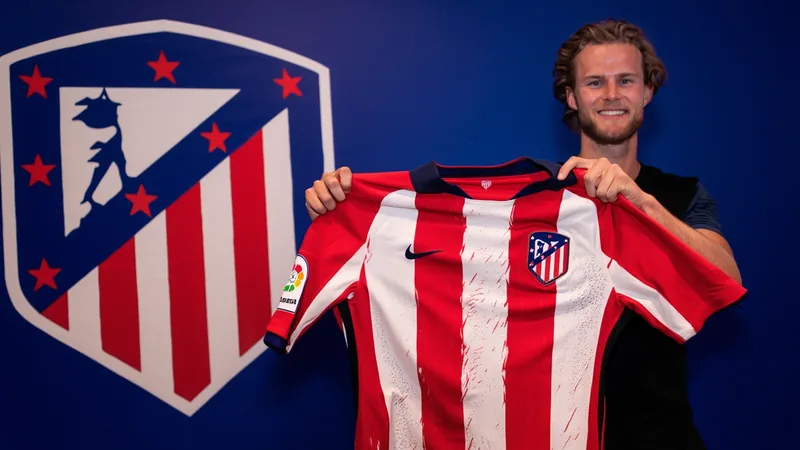 Morten Hjulmand posing with an Atlético Madrid jersey in front of the club's crest.