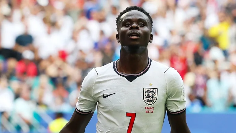 Bukayo Saka: Jude Bellingham told me to get hat-trick Bukayo Saka speaking to media, with Jude Bellingham in the background