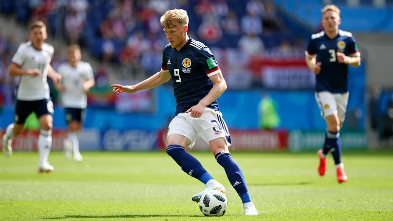 Lewis Ferguson in action for Scotland at the World Cup, wearing the national team kit.