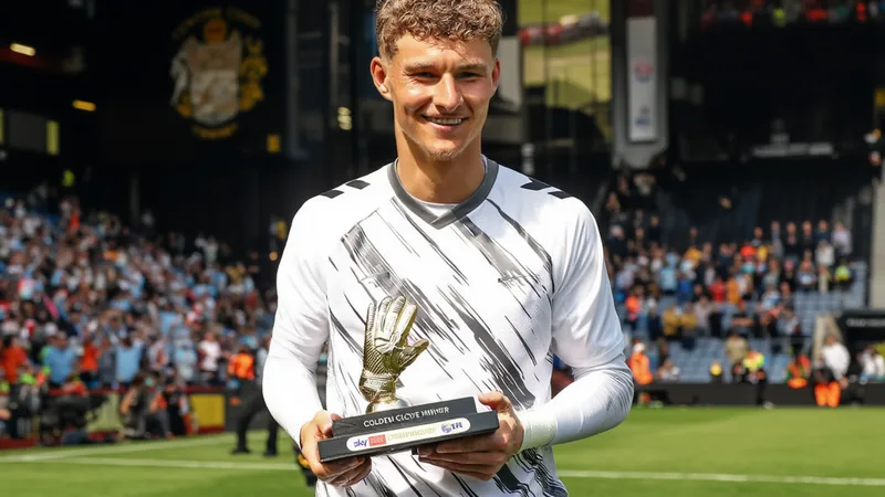 Coventry City agree Carl Rushworth deal with medical booked Carl Rushworth in goalkeeper kit, holding a golden glove award, with Coventry City badge in background. — latest news and analysis.