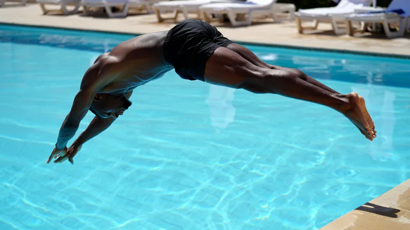 Djed Spence Makes a Splash at World Cup Hotel Pool Djed Spence diving into a hotel pool during the World Cup, captured in a candid moment.
