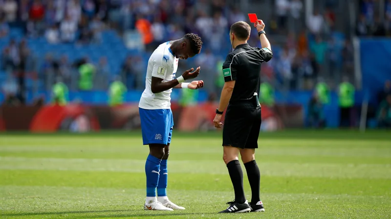 Embolo sent off for diving in Switzerland-Argentina match Breel Embolo looking distraught as he is shown a red card by the referee during a match.