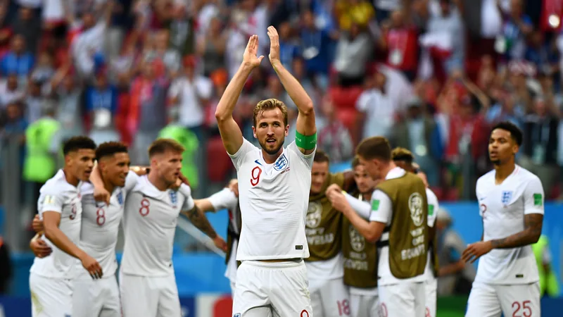 Harry Kane celebrates scoring the winning goal for England in a World Cup match, with teammates surrounding him. — latest news and analysis.