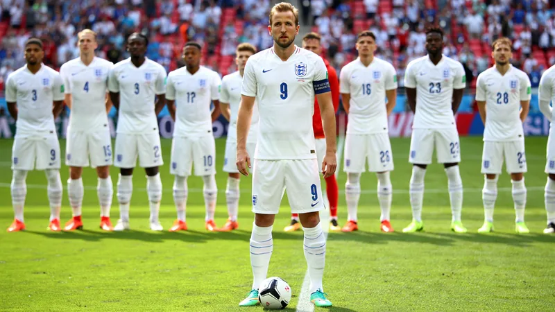 England's tactical lessons from DR Congo win ahead of Mexico clash England players in white shirts line up on a football pitch, with Harry Kane holding the ball, preparing for a match against Mexico.