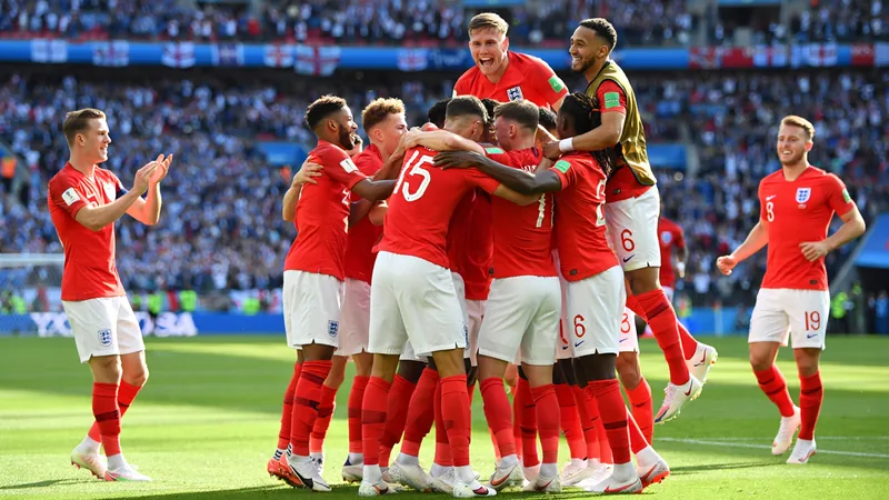 England's World Cup path to final examined England football team celebrating a goal on the pitch with fans in the background
