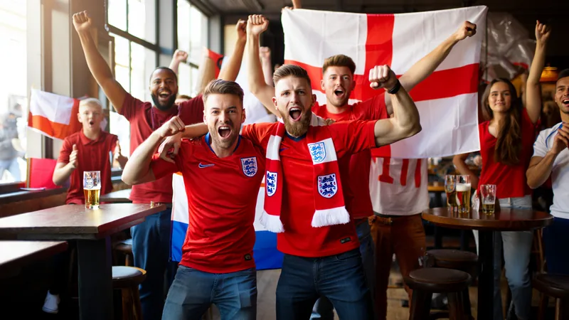 England World Cup win: Fan stories of all-nighters and school England fans celebrating in a pub during the World Cup match against Mexico, with flags and scarves visible. — latest news and analysis.