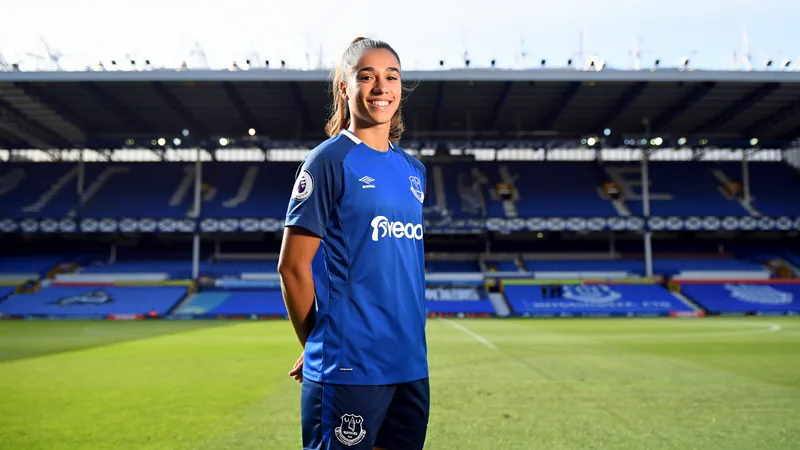 Everton sign France forward Noemie Mouchon from Leicester Noemie Mouchon in Everton kit, smiling, with Goodison Park in background