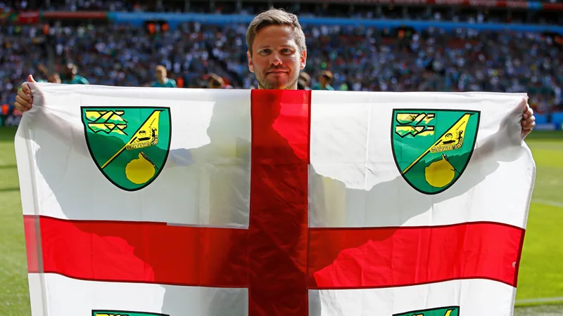 Fan waves same homemade flag at eight World Cups Paul Green holding his large homemade Wisbech flag with St George's Cross and Norwich City emblems at a World Cup match.