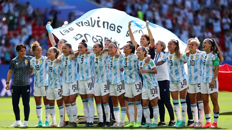 Argentina players celebrate with a banner reading 'Las Malvinas son Argentinas' after their semi-final win over England at the Women's World Cup.