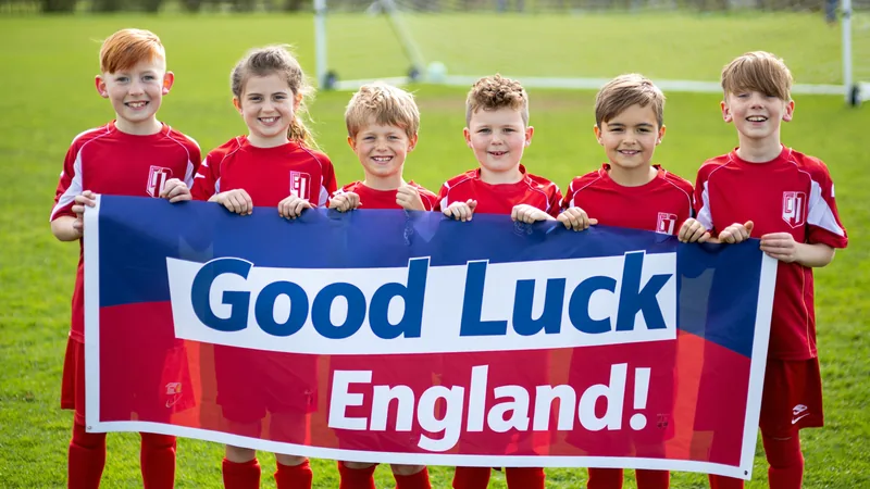Epsom Eagles Send Good Luck to England Squad Children from Epsom Eagles grassroots club holding a banner wishing England luck