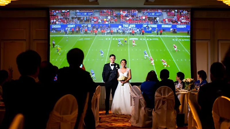 Guests tell Somerset couple to show England match at wedding A bride and groom at a wedding reception with a television screen showing a football match in the background. — latest news and analysis.