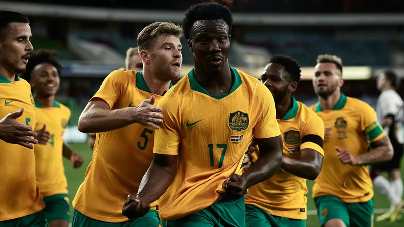 Nestory Irankunda celebrating his World Cup goal for Australia against Türkiye, with teammates surrounding him on the pitch in Vancouver.