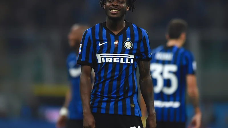 Inter reach verbal agreement with Yan Bisseck on new deal until 2031 Yan Bisseck in Inter Milan kit, smiling during a match, with teammates in background.