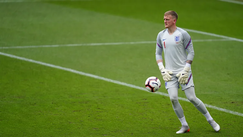 Jordan Pickford in England goalkeeper kit, focused on the pitch