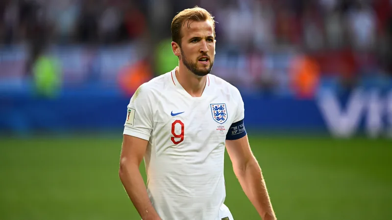 Harry Kane in an England shirt, looking determined on the pitch.