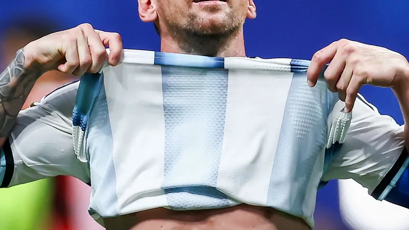 Messi's Letter to Argentina Before World Cup Final Lionel Messi holding a handwritten letter with Argentine flag colors in the background, on the eve of the World Cup final.