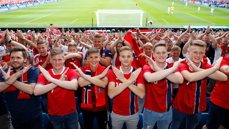 Norway fans performing the Viking row gesture in a stadium