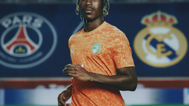 Yan Diomande in action on the pitch, with PSG and Real Madrid logos in background