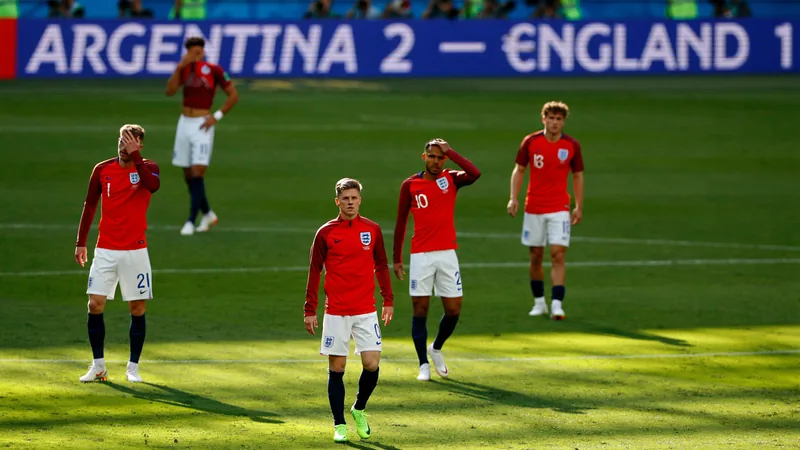 England players dejected after losing to Argentina in the World Cup semi-final, with scoreboard showing 2-1. — latest news and analysis.
