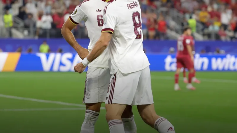 Spain players celebrating a late winning goal in a FIFA World Cup match.