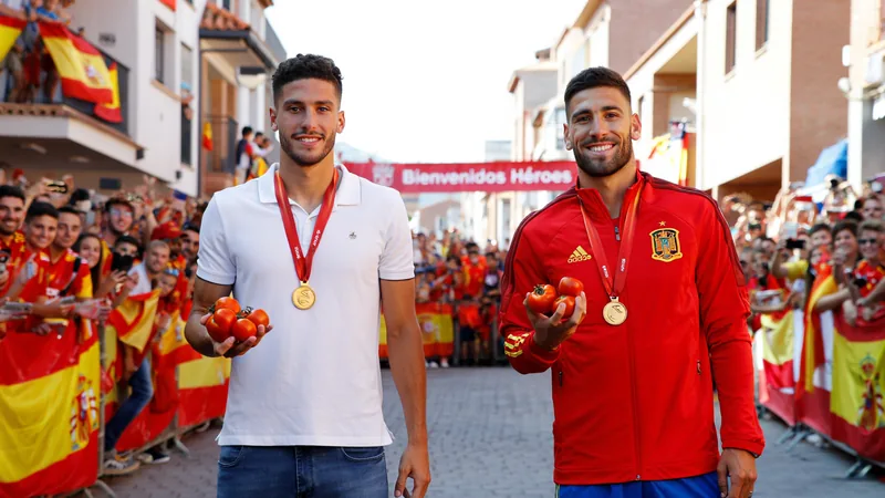 Spain World Cup winners get 150kg of tomatoes Spain midfielders Fabian Ruiz and Gavi wearing gold medals and holding tomatoes during a hometown reception in Los Palacios y Villafranca.