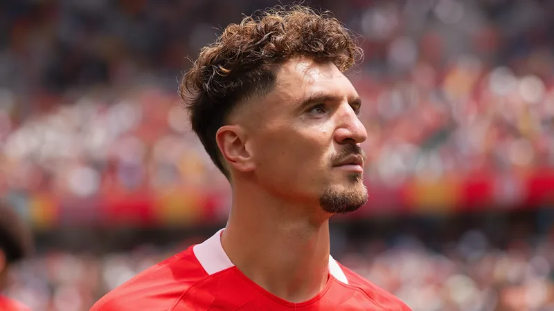 Thomas Meunier in action for Belgium, wearing red jersey, during a football match.